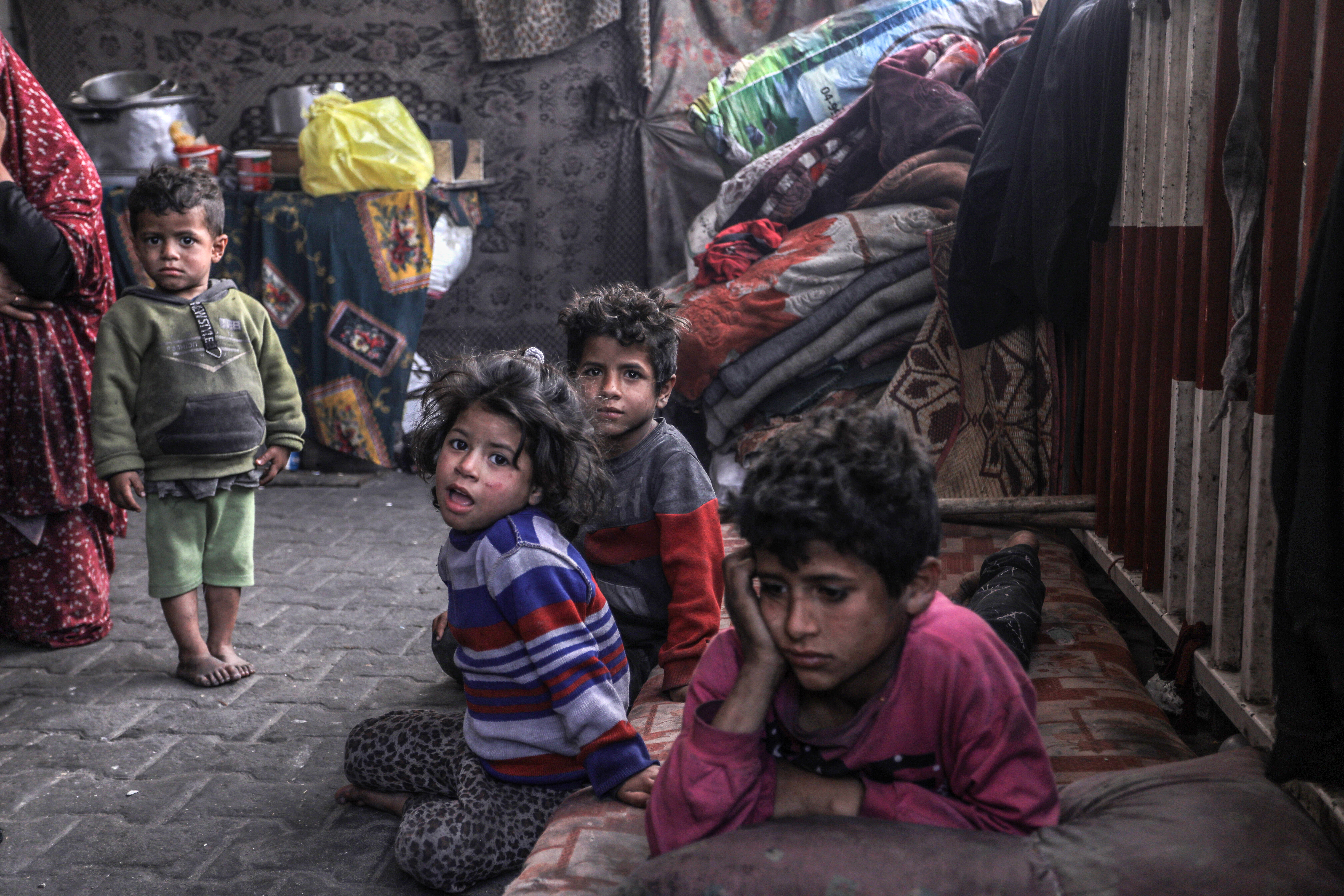 Palestinian residents are seen March 28 trying to continue their daily lives inside makeshift tents.