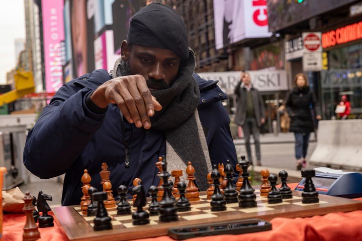 Tunde Onakoya, 29, a Nigerian chess champion and child education advocate, plays a chess game in Times Square, Friday, April 19, 2024 in New York. (AP Photo/Yuki Iwamura)