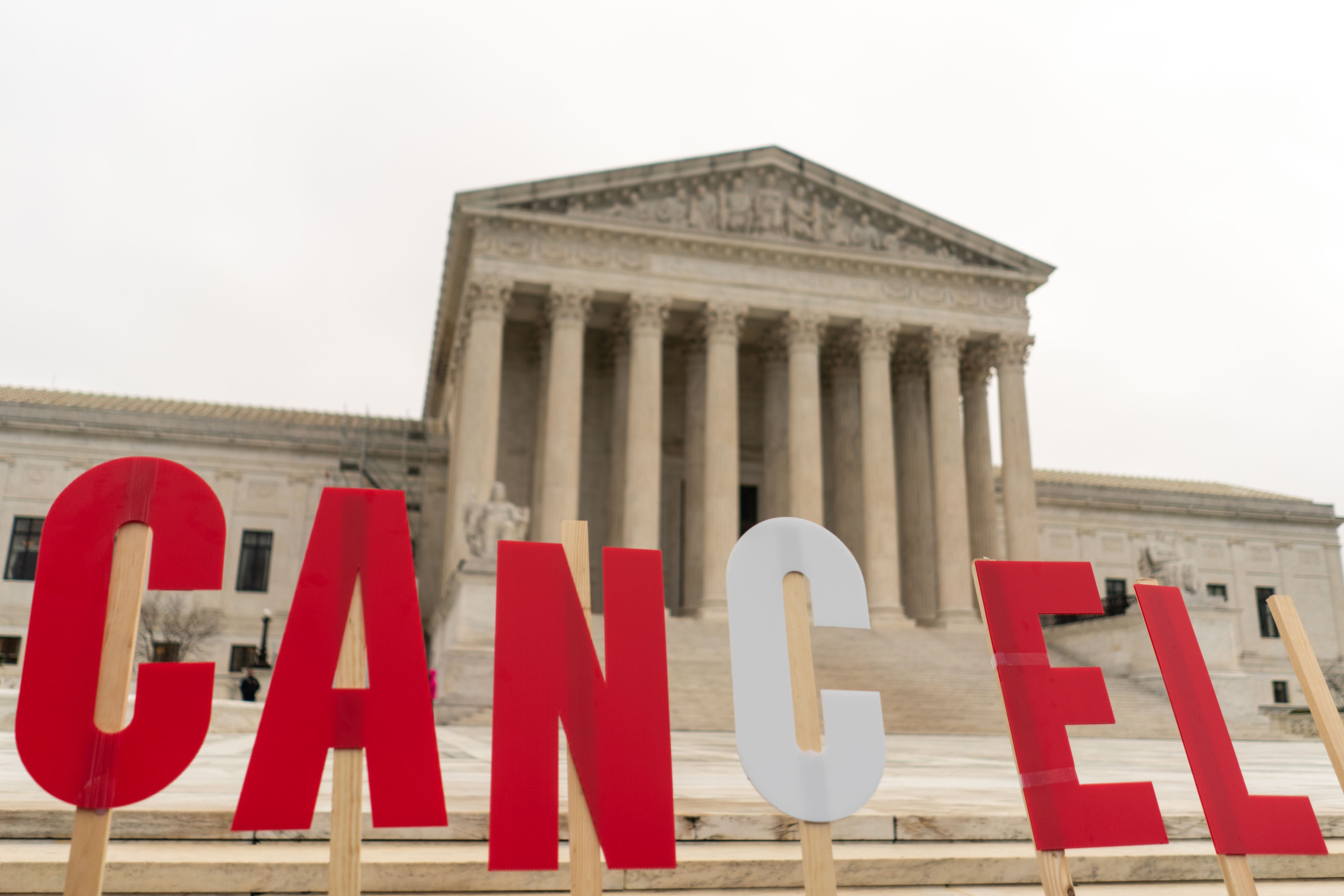 People rally to show support for the Biden administration's student debt relief plan in front of the U.S. Supreme Court in 2023. The Supreme Court rejected Biden's earlier attempt at one-time cancellation, saying it overstepped the president's authority.