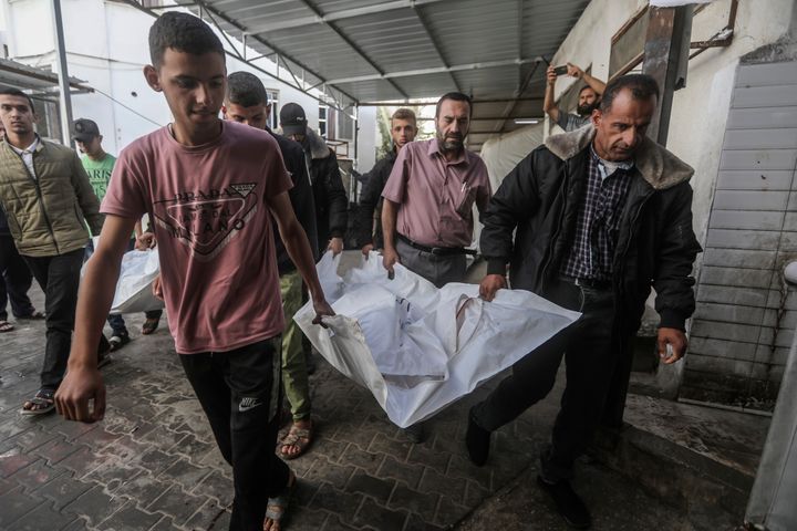 The Chahine family prepares to bury two adults and five boys and girls under the age of 16 after an overnight Israeli strike in Rafah, southern Gaza Strip, Friday, May 3, 2024. An Israeli strike on the city of Rafah on the southern edge of the Gaza Strip killed several people, including children, hospital officials said Friday. (AP Photo/Ismael Abu Dayyah)