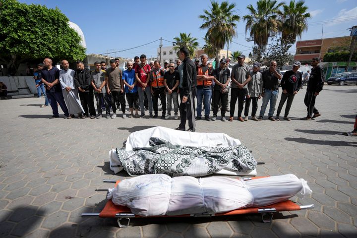 Palestinians prayer next to the bodies of their relatives who were killed in an Israeli airstrike in Gaza Stirp, at the Al Aqsa hospital in Deir al Balah, Gaza, Saturday, May 4, 2024. (AP Photo/Abdel Kareem Hana)