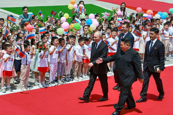 Russian President Vladimir Putin, left, and North Korea's leader Kim Jong Un, foreground right, attend the official welcome ceremony in the Kim Il Sung Square in Pyongyang, North Korea, on June 19, 2024. 