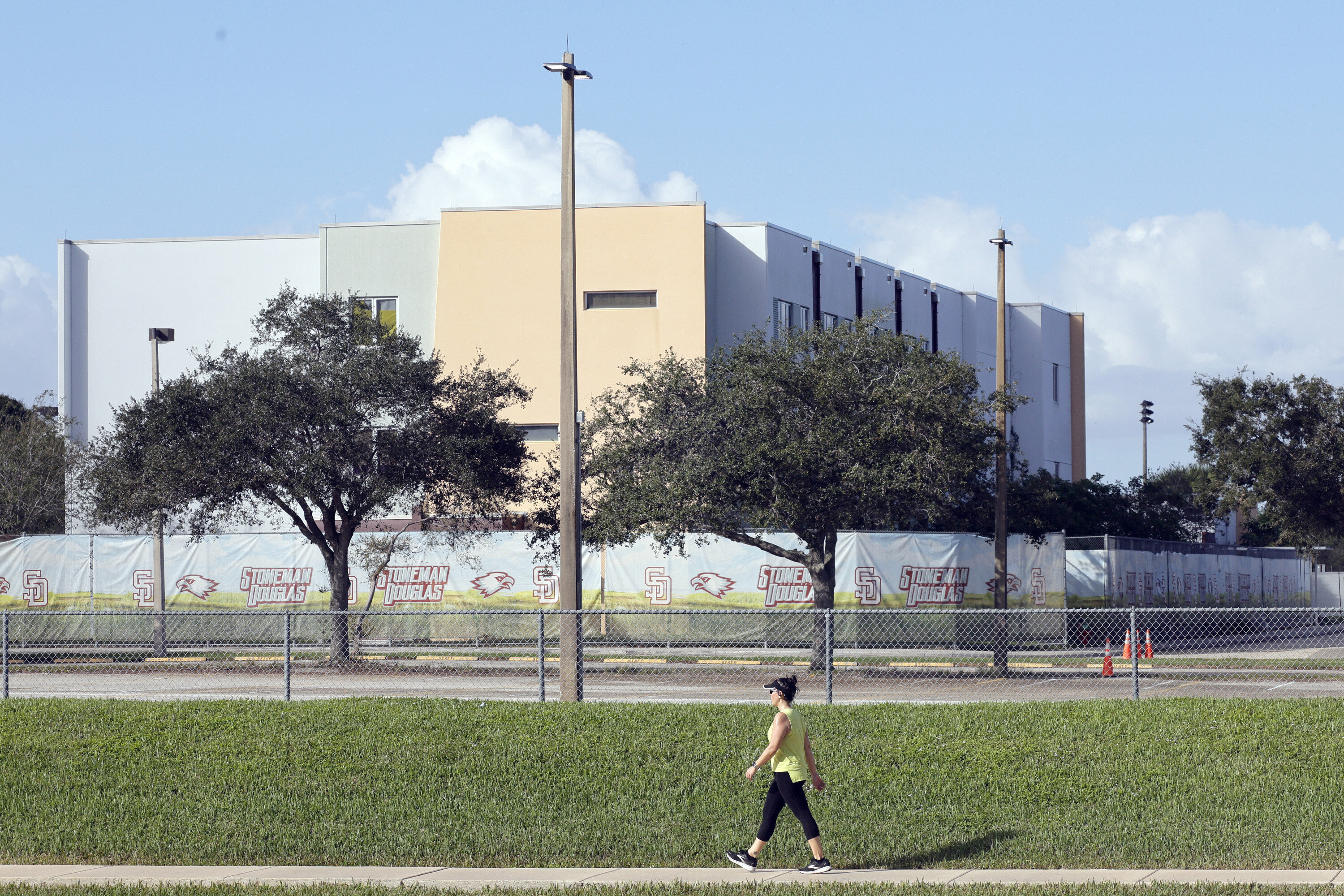 A woman walks past the site of the 2018 school shooting in Parkland, Florida, that killed 17 people.