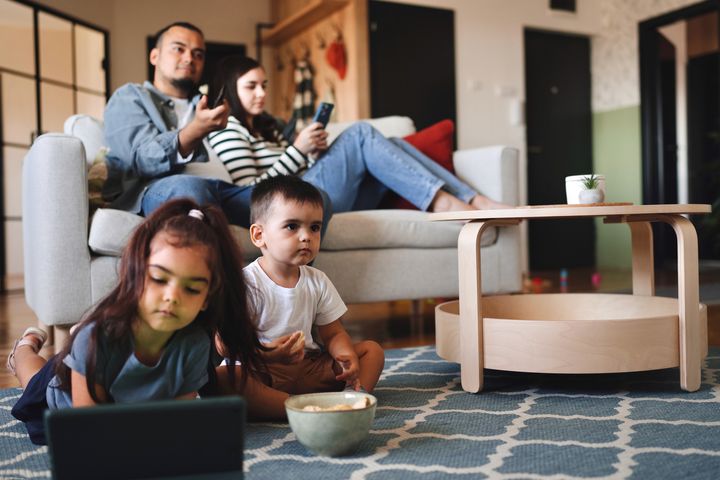 People using technology and relaxing at home