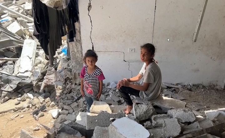 This image from video shows children sitting amongst rubble in Yarmouk Sports Stadium Friday, July 5, 2024 in Gaza City, Gaza Strip. (AP Photo)