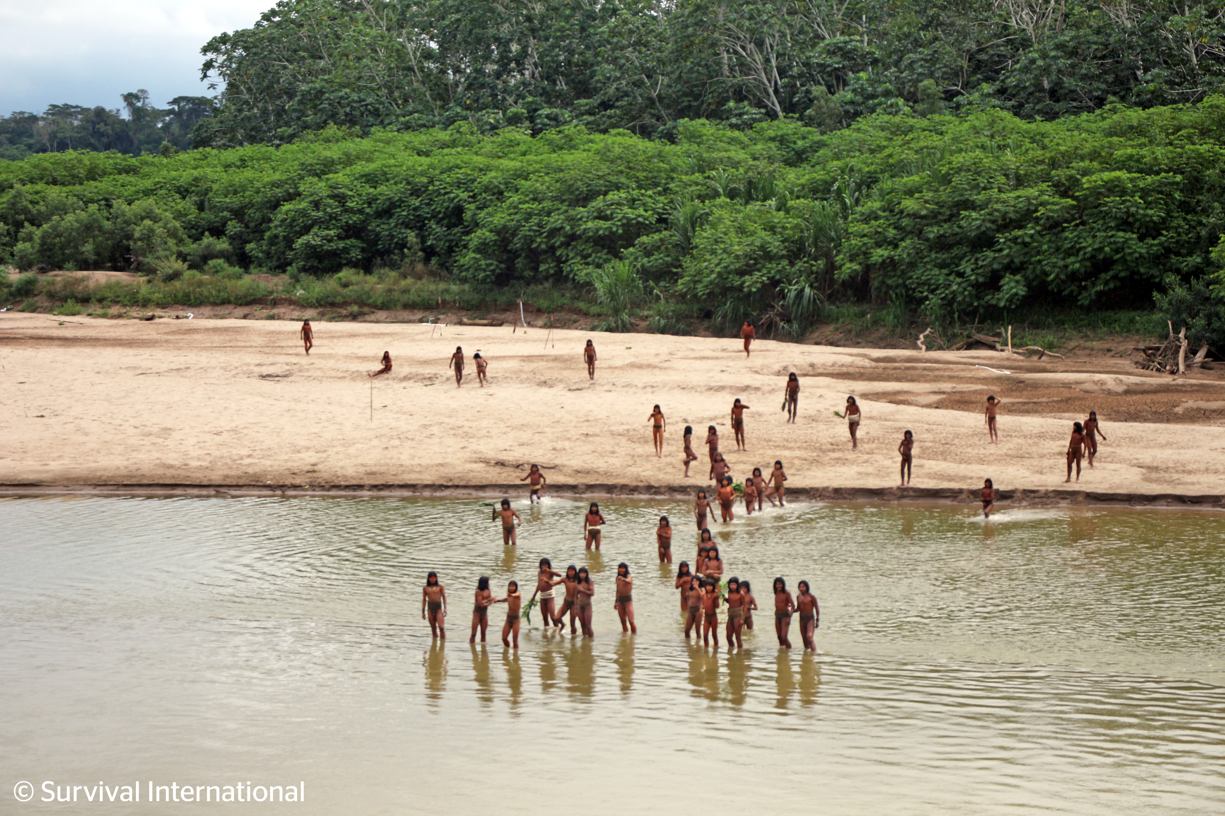 Photos published Tuesday show members of the Indigenous Mashco Piro tribe along a beach near the Yine village of Monte Salvado in southeast Peru.