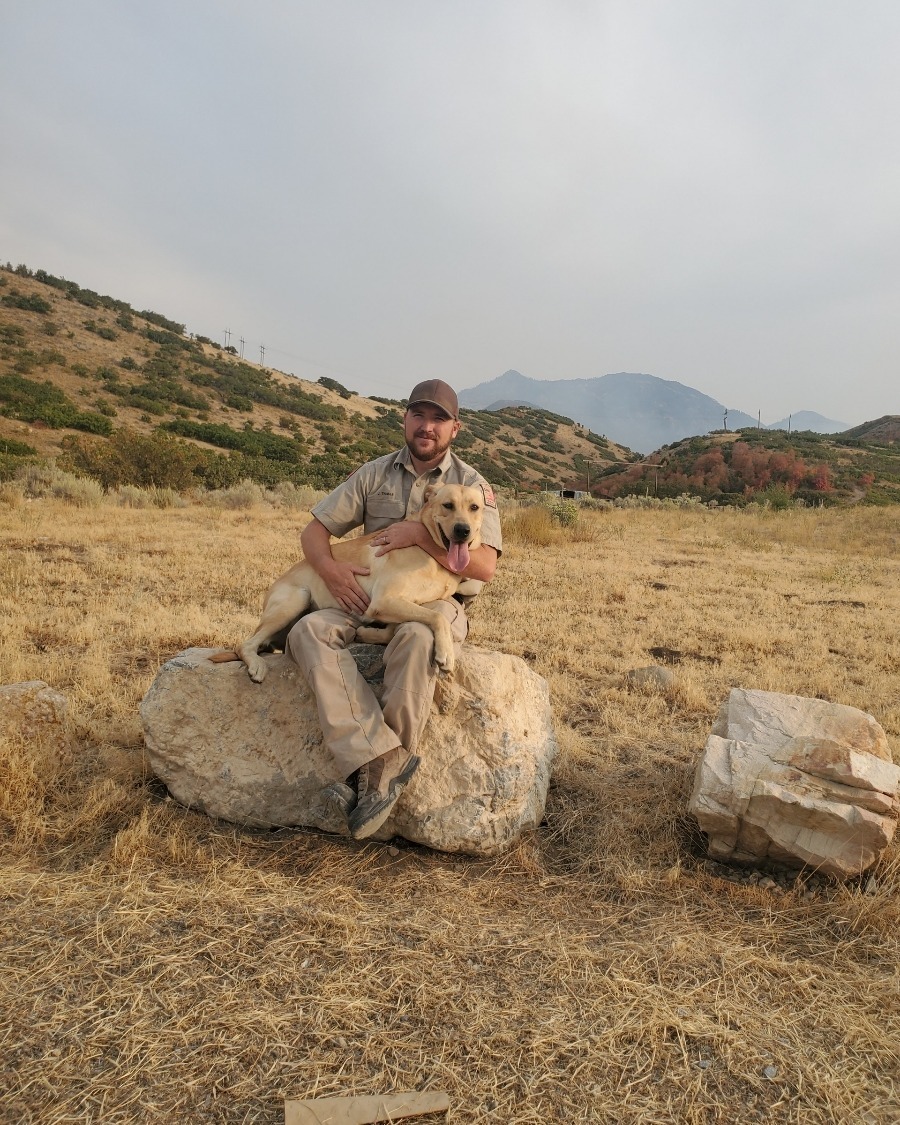 Conservation officer James Thomas is pictured with Kip, a search dog who was crucial to a woman's rescue in Utah.