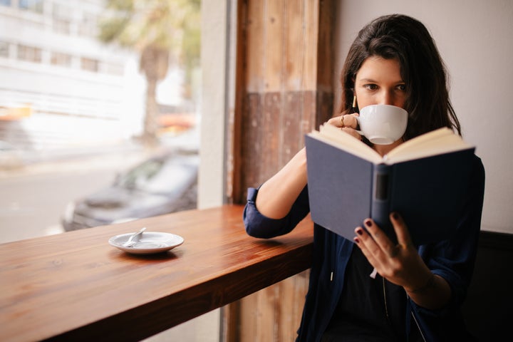 Bring a book to a cafe or restaurant bar.