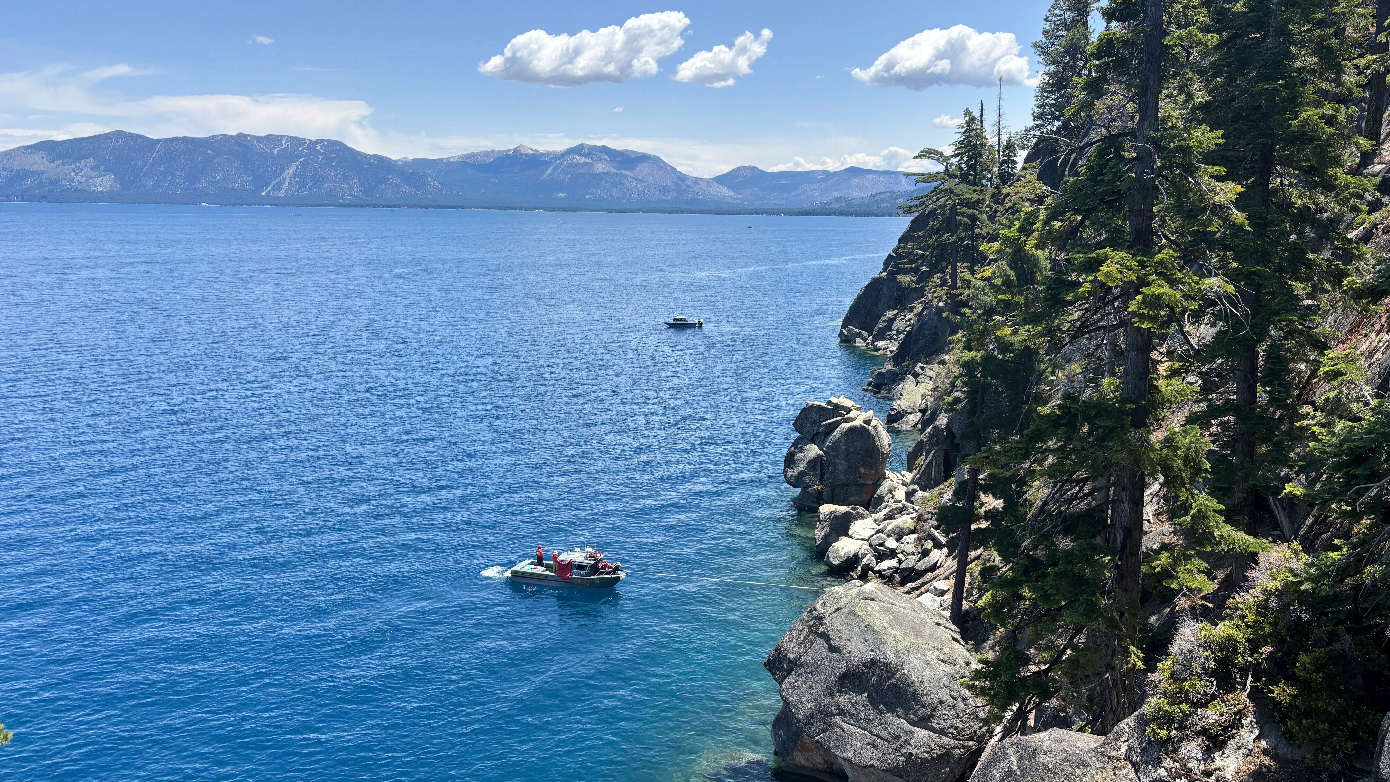 Authorities conduct searches along the shore at D.L. Bliss State Park after a weekend incident in which a boat capsized in South Lake Tahoe.